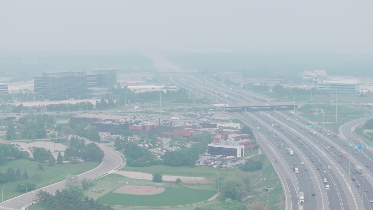 Heavy wildfire smoke over Mississauga, poor air quality, hazy view of the cityscape