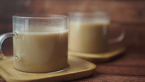 two cups of tea on wooden coasters