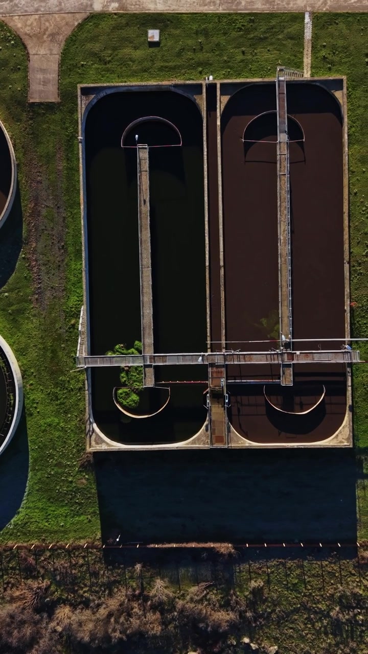 Water treatment facility showing tanks and processing systems in operation