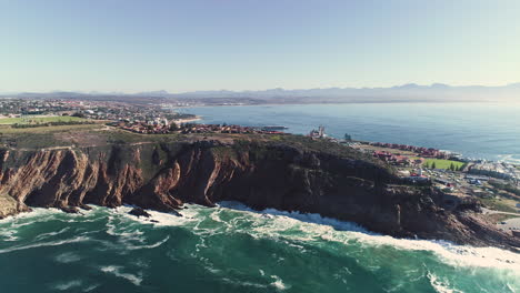 aerial - ascending drone flying backwards away from cape st blaize cliffs, showing the lighthouse and beautiful surrounding coastline