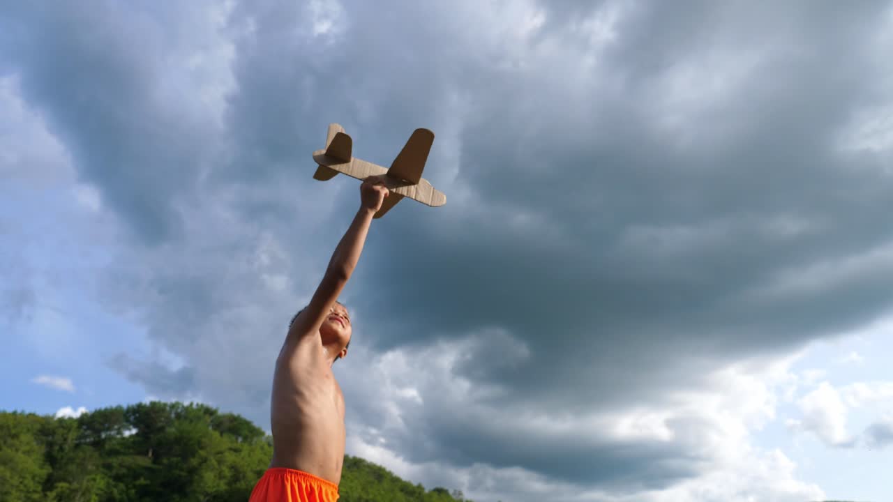 A Child Launches a Cardboard Airplane