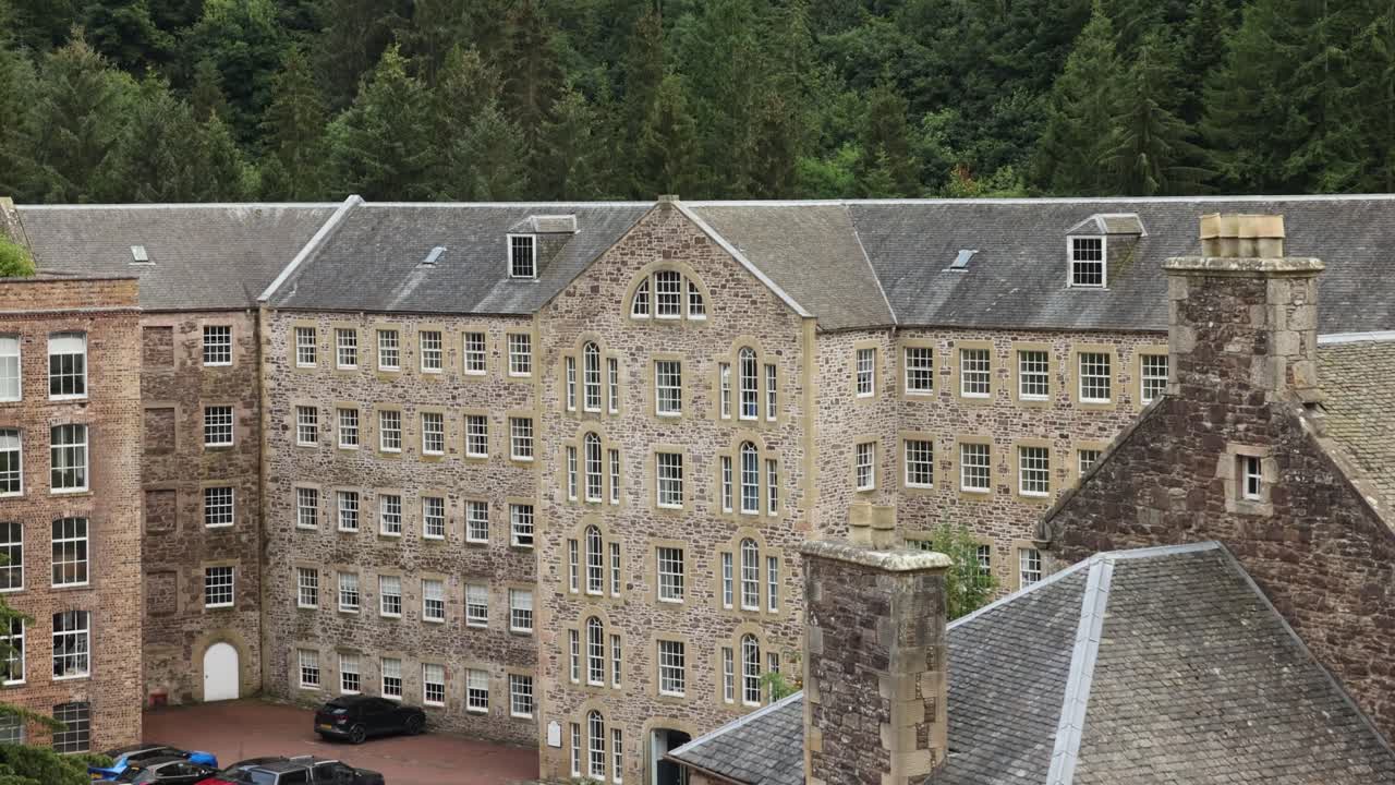 Slow establishing shot of car sparked outside the New Lanark Mill Hotel