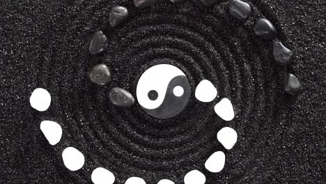 japanese zen garden with yin yang stones in textured sand