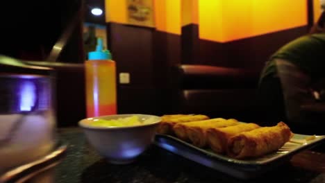 Pan-shot-of-typical-dinner-in-Cambodia-,-noodles-and-Spring-rolls