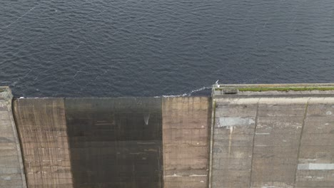 booth wood reservoir aerial view close up on lake water supply splashing over concrete dam spillway gate