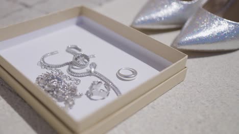 silver jewelry and high heels in a gift box