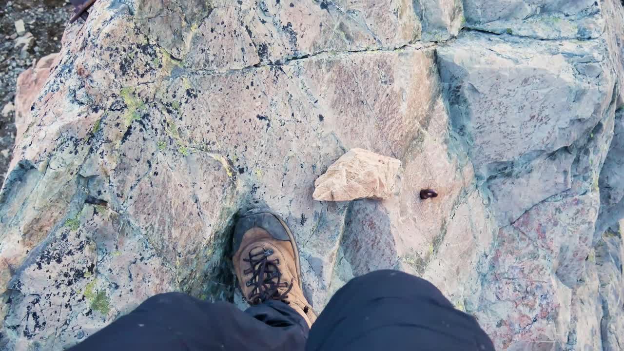 POV hiker walking over boulders