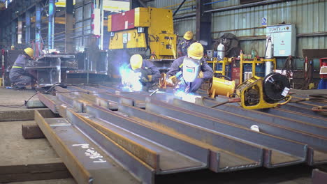 welders working at metal fabrication making structural channel beam