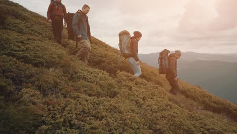 the four active people walking down in a mountain