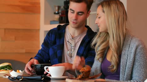 couple interacting with each other while having coffee in cafe 4k