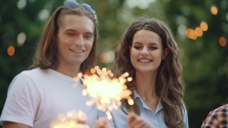 young people at celebration party with sparklers