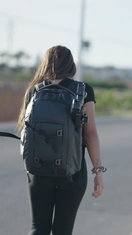 woman walking with camera backpack