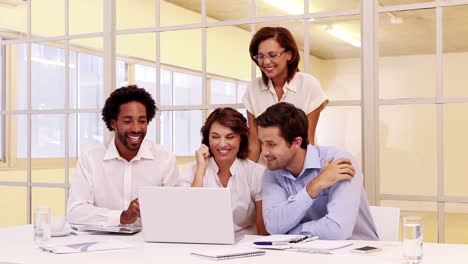 Business-team-having-a-meeting-and-cheering