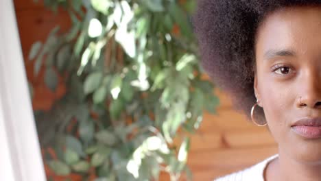 Half-portrait-of-happy-african-american-woman-at-home-with-copy-space,-in-slow-motion