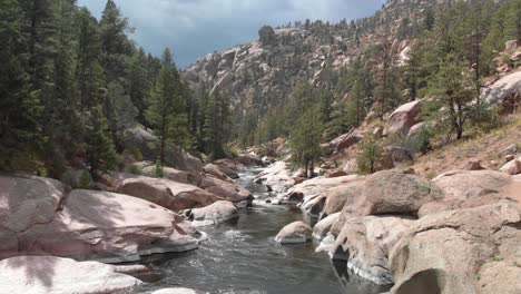 low aerial follows down stream in rocky cheesman canyon, colorado