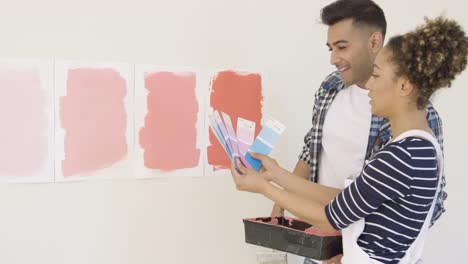 young couple checking paint swatches