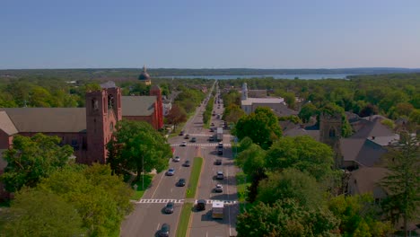 beautiful drone shot passing the churches and the historical center of the downtown mainstreet canandaigua, new york near canandaigua lake