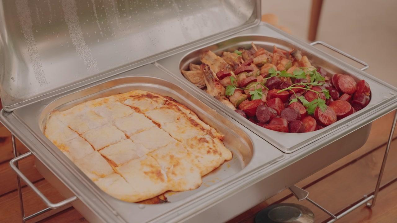 catering buffet serving lasagna and sausage with herbs