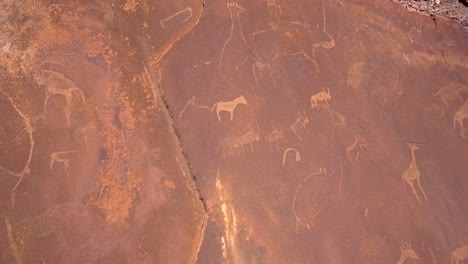 pan wideshot of multiple rock paintings at twyfelfontein, nambia