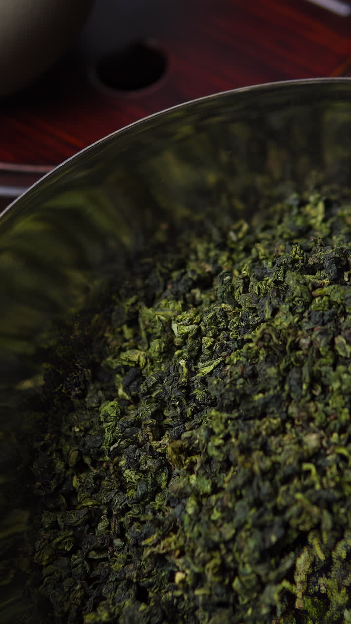 Loose leaf oolong tea in a metal bowl