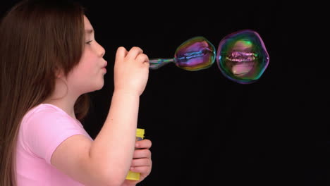 little girl making bubbles