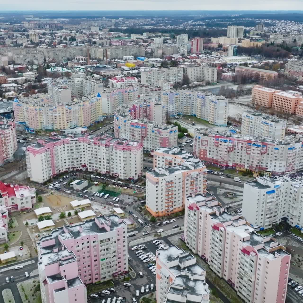 High-rise apartment buildings in a modern residential urban area. Drone flight over the beautiful city district against the cityscape