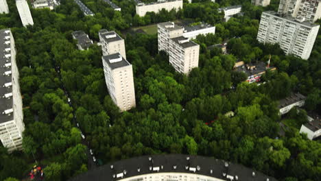 aerial view tilting over a round house, revealing industrial suburbs of moscow, russia