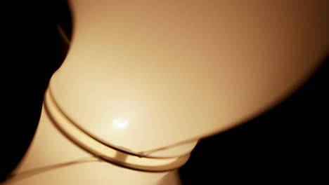 a futuristic designer lamp spinning. static close-up shot