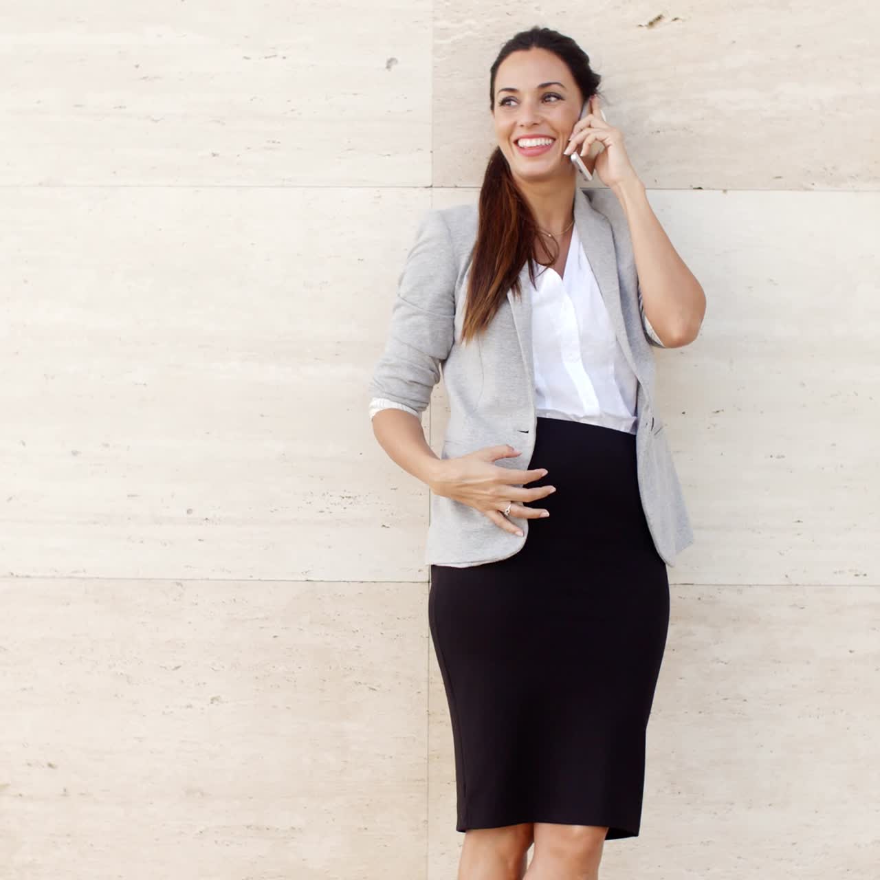 en smuk kvinde, der smiler, mens hun snakker på en mobil