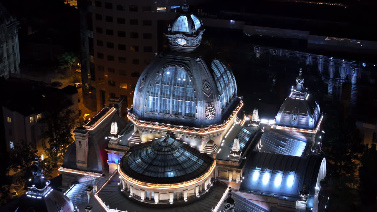 Aerial drone view of the Palace of the Deposits and Consignments illuminated in Bucharest, Romania at night