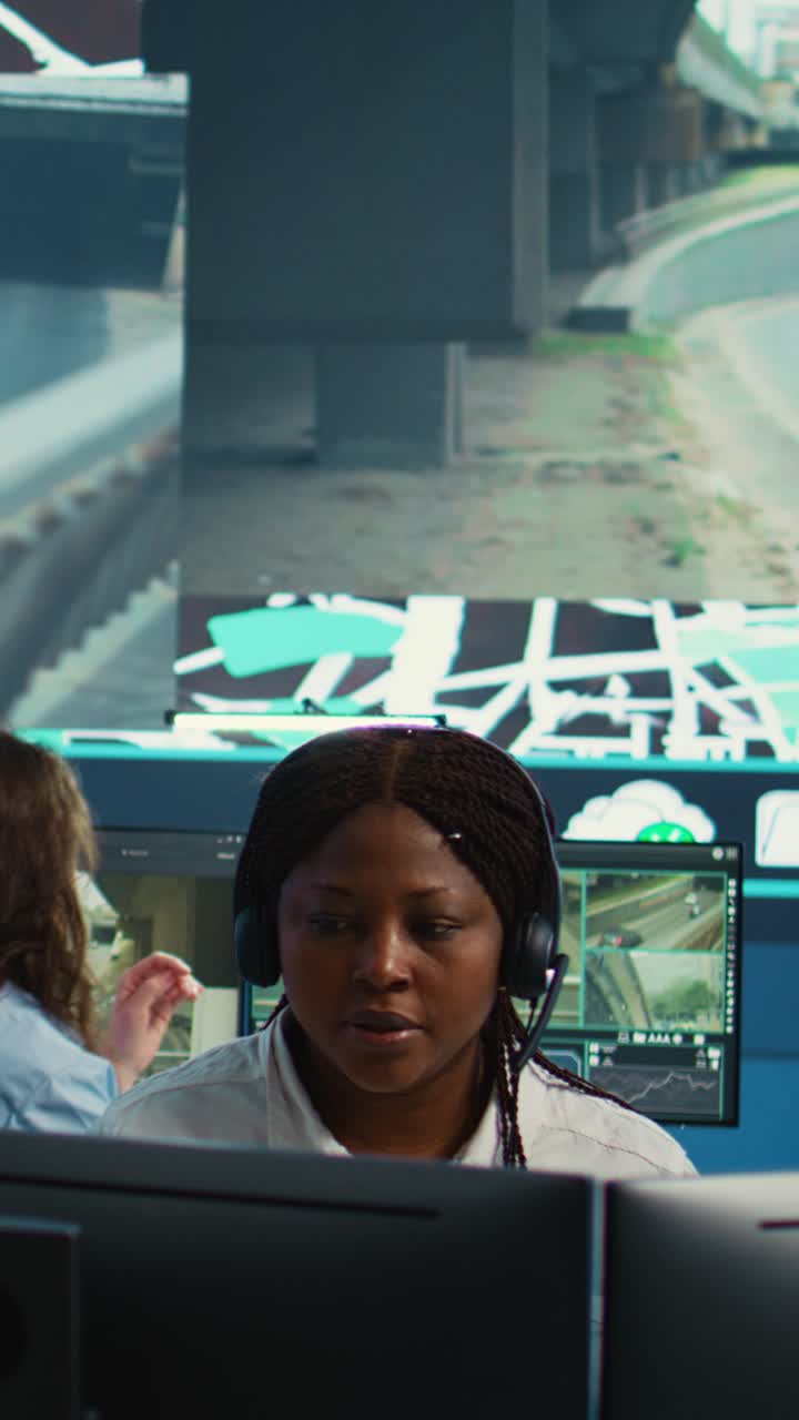 African American Woman Monitoring Traffic on Computer in Control Room