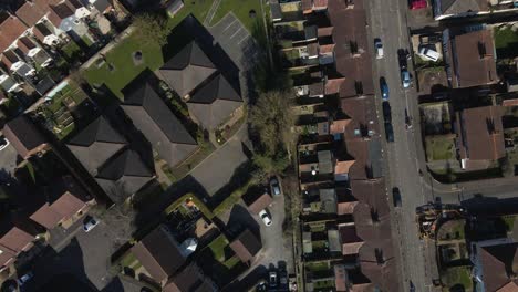 4k aerial view of a residencial area in taunton somerset, united kingdom, drone moving back and showing the buildings roofs and street