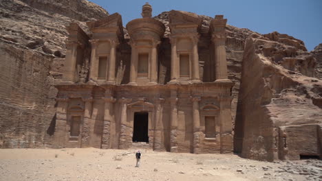 Lonely-Man-in-Front-of-Monastery-Carved-in-Sandstone-Cliff