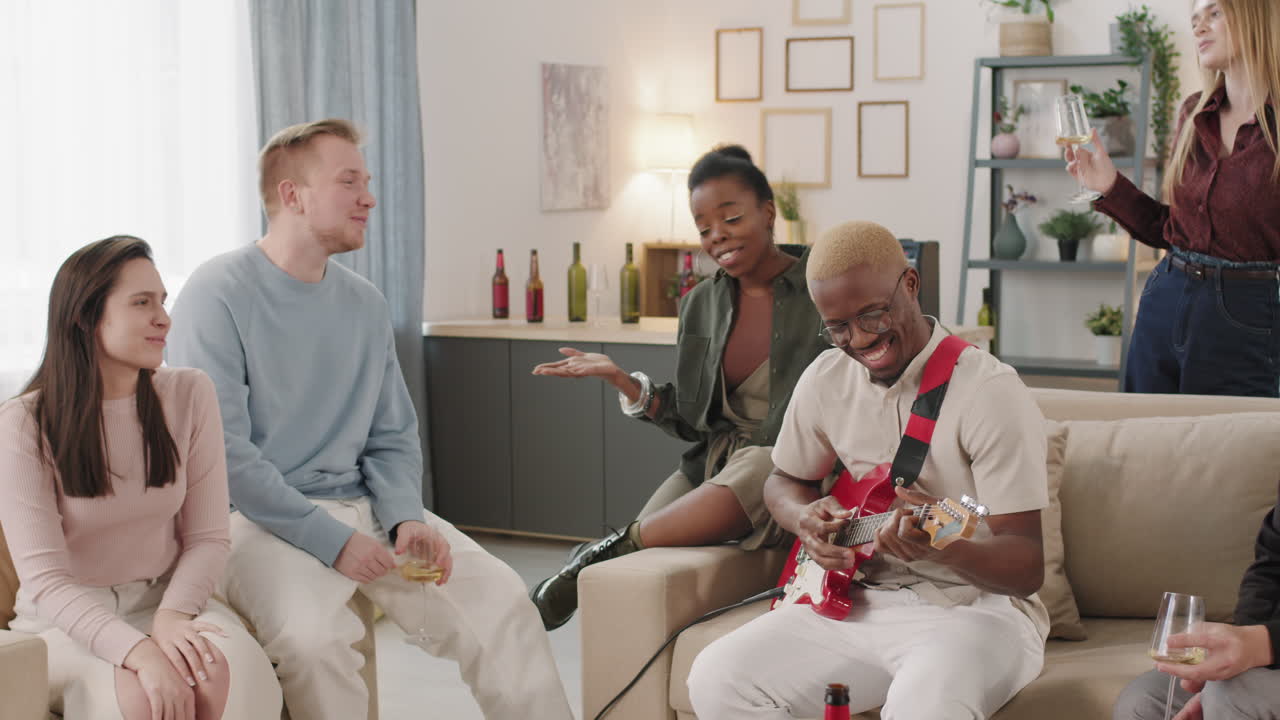 Man Playing Song for Friends at Get-Together