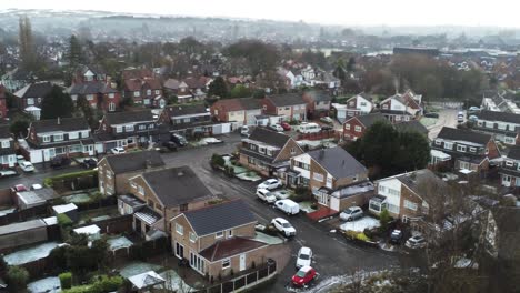 snowy aerial village residential neighbourhood winter frozen north west houses and roads push in