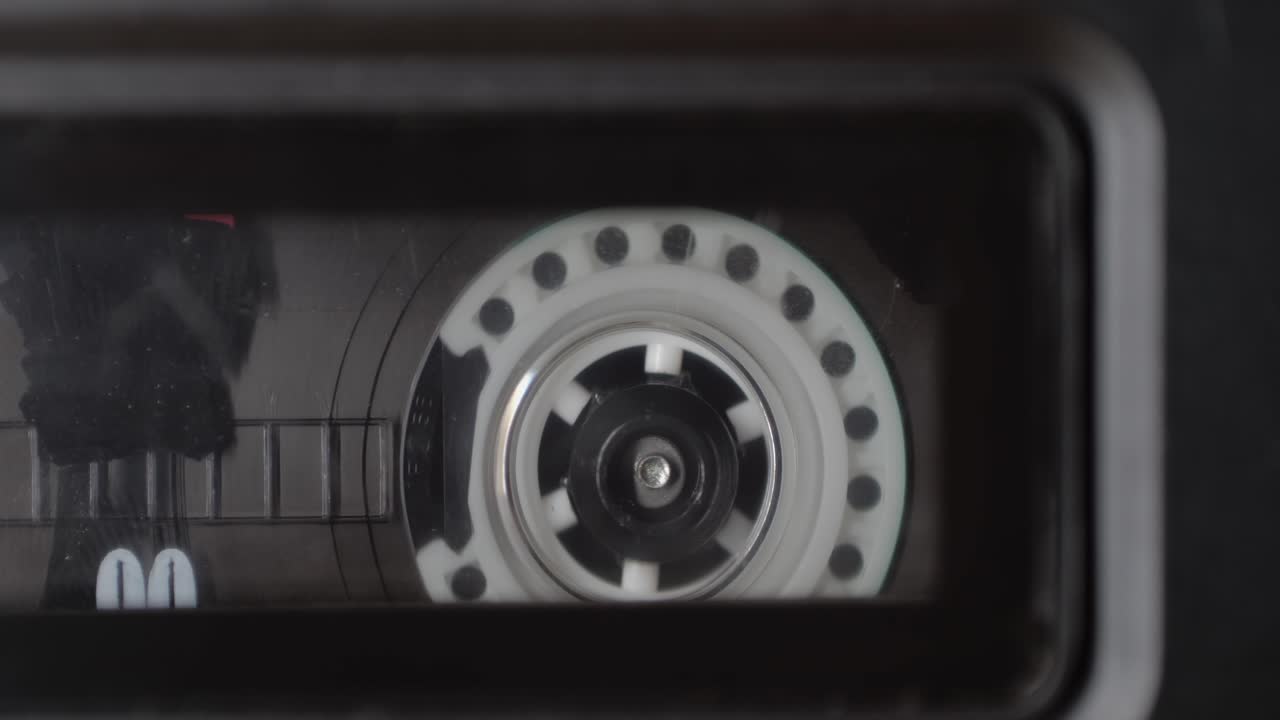 Retro radio tape recorder, audio cassette close-up. Listening to music, old radio boom box player, macro of vintage music listening.