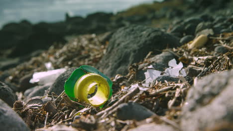 broken plastic waste lies washed up on a beach