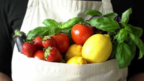 a colorful collection of fresh fruits and vegetables in an apron pocket, showcasing nature's bounty and culinary inspiration