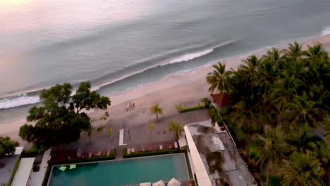 Aerial-fly-over-luxury-resort-in-Bali-at-sunset