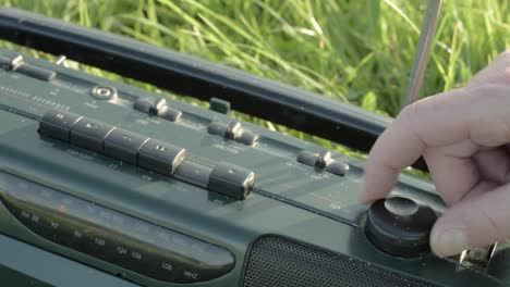 hand tuning the dial on fm am portable radio