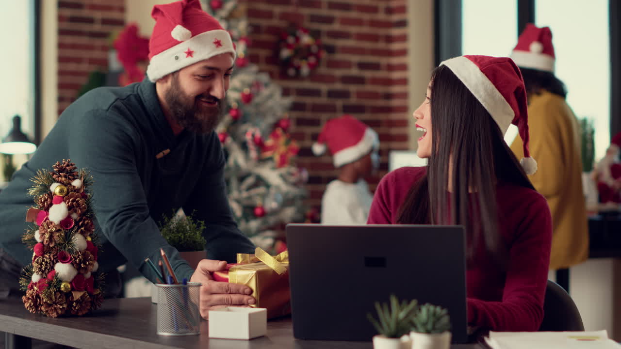 Asian woman receiving christmas present from colleague