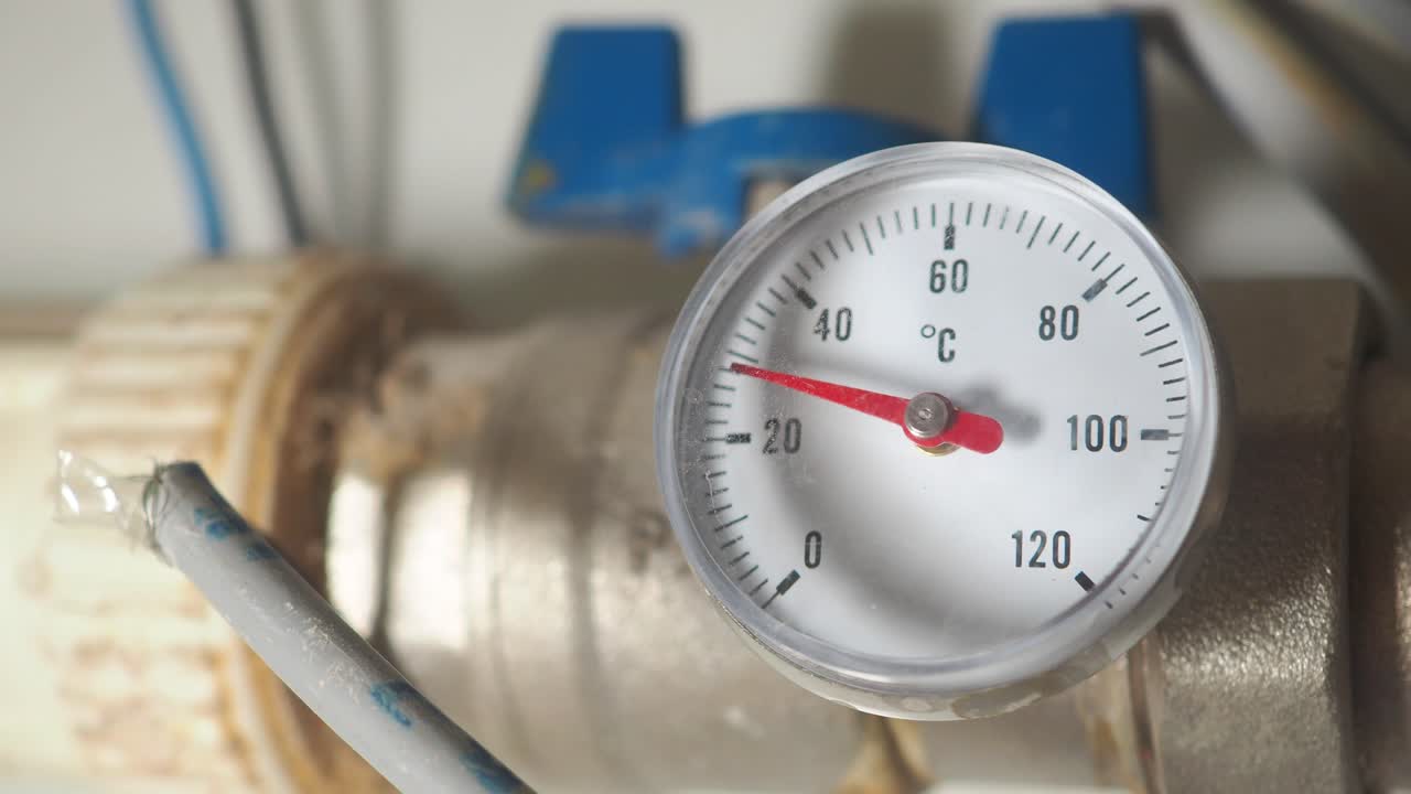 Close-up of a thermometer on a pipe