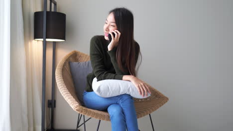 asian woman chatting with friends on cellphone