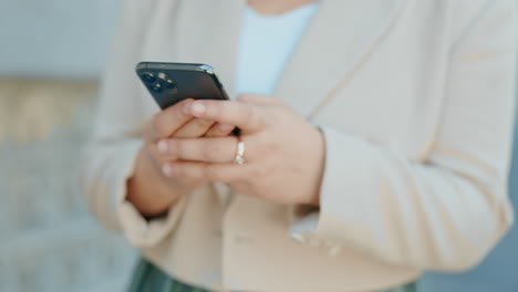 woman typing on smartphone