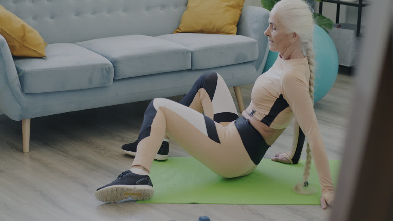 Senior Woman Doing Stretching Exercises at Home