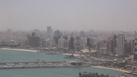 wide panning shot of kuwait city skyline with expansive urban and coastal view