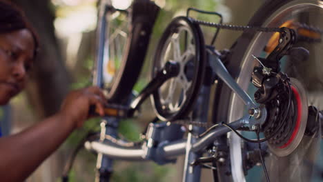 skillful woman mending bicycle crank arm