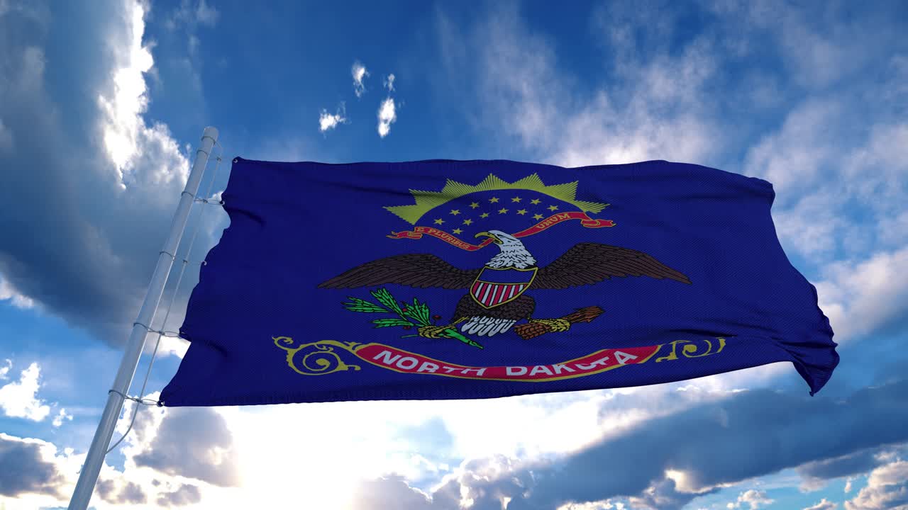 North Dakota flag on a flagpole waving in the wind, blue sky background. 4K