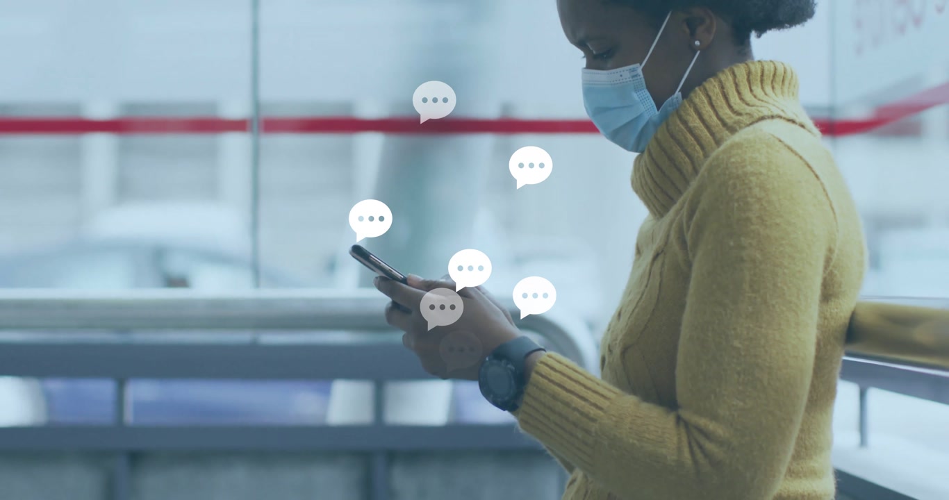 Masked woman holding phone on transit stop receiving graphic chat bubbles showing messaging tech