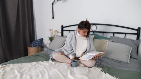 woman reading a book in bed